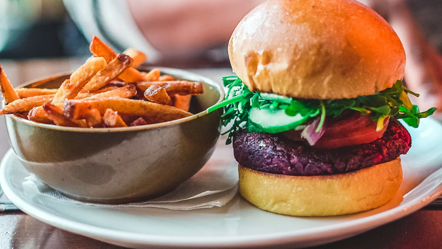 A plant-based meal consisting of a veggie burger and fries